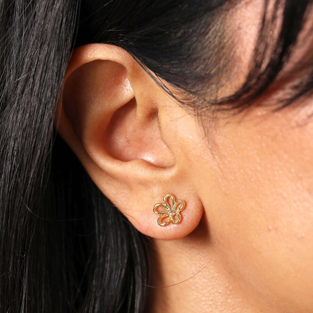 Lisa Angel Flower Outline Stud Earrings in Gold with Flower Backs on Model