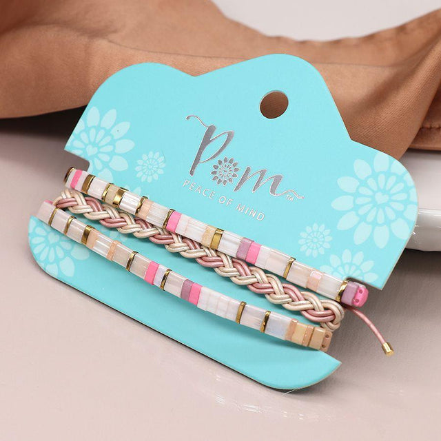 Pom Boutique Gold and Pastel Pink Beaded and Plaited Leather Triple Bracelet Set on Presentation Card